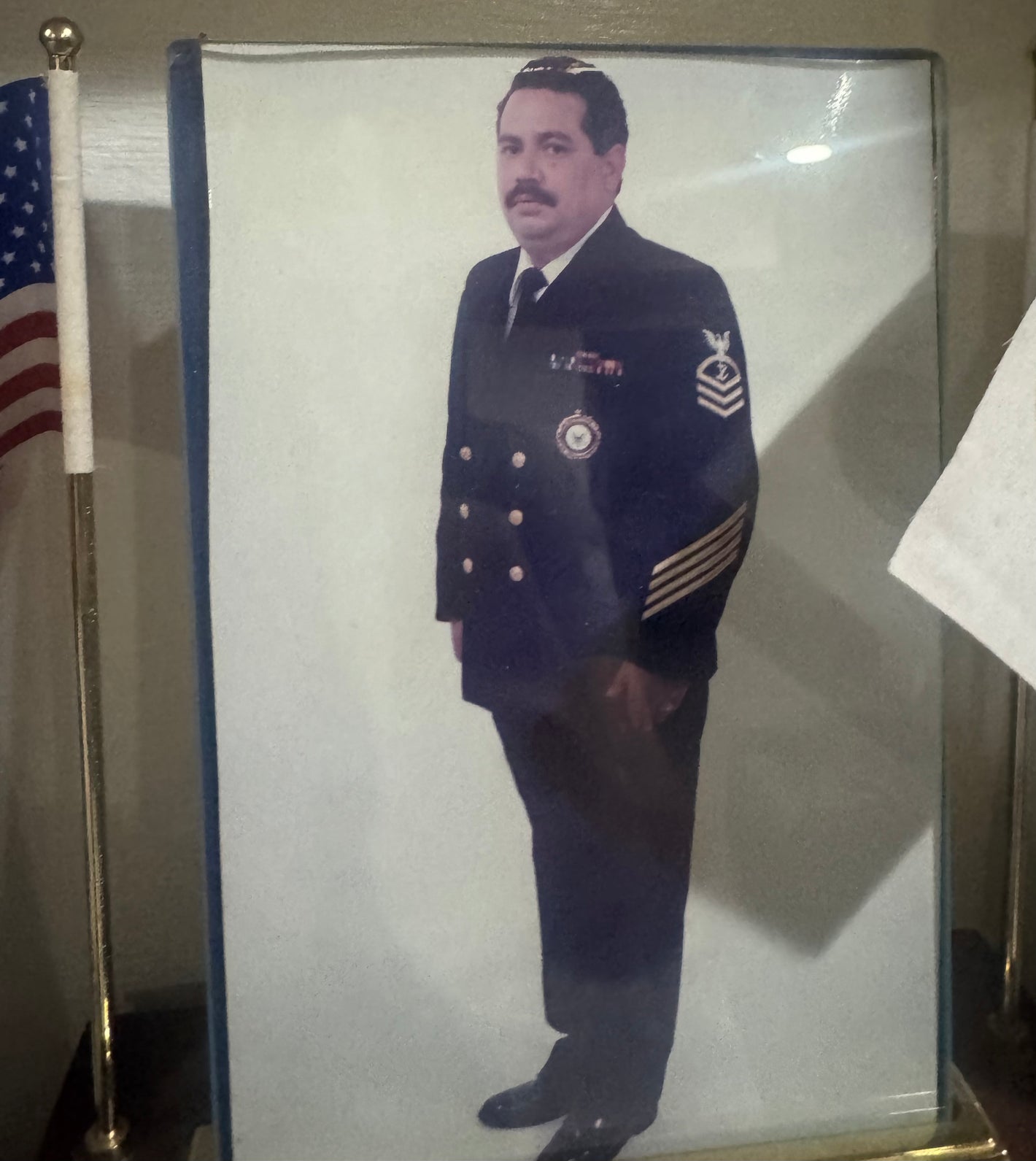 Rick Flores in US Navy Senior Chief Petty Officer dress uniform with American flag