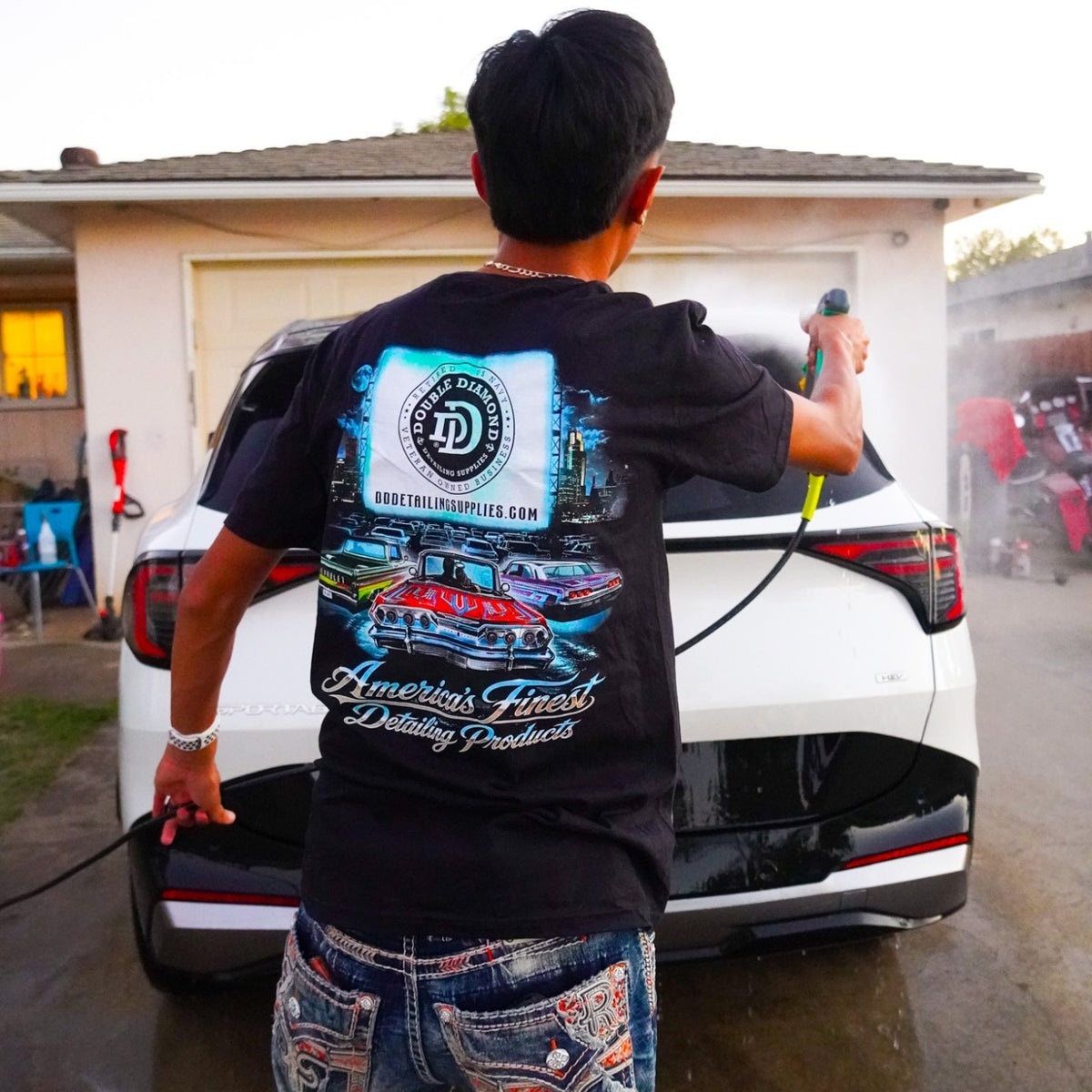 Drive In Tee back print, worn while rinsing a white SUV