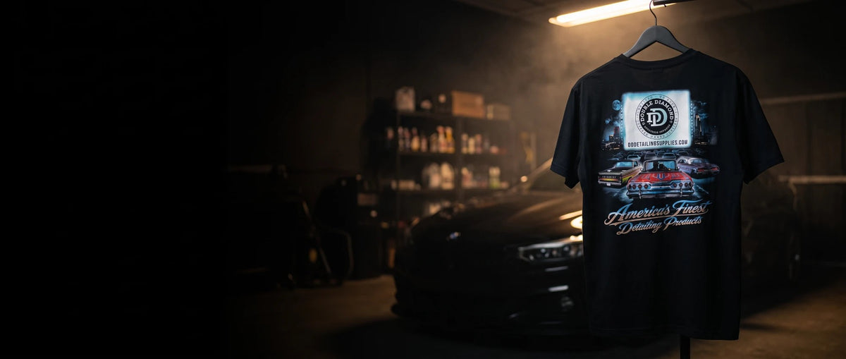 Drive In Tee hanging in a dark detailing garage, back print showing